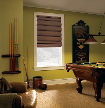 Roman shades in St. George pool room with green walls.
